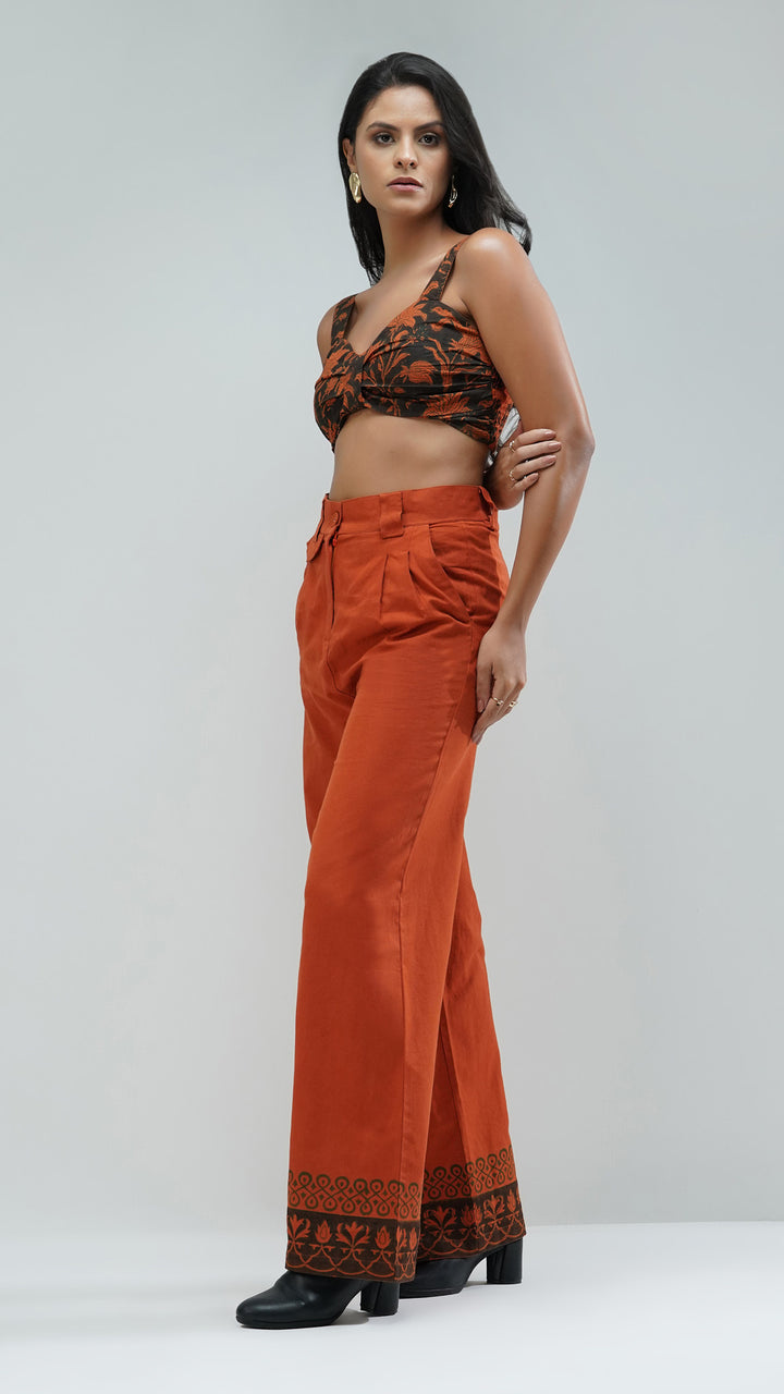 Rust Wide Leg Printed Trousers, emphasizing the designer craftsmanship in the printed hem.