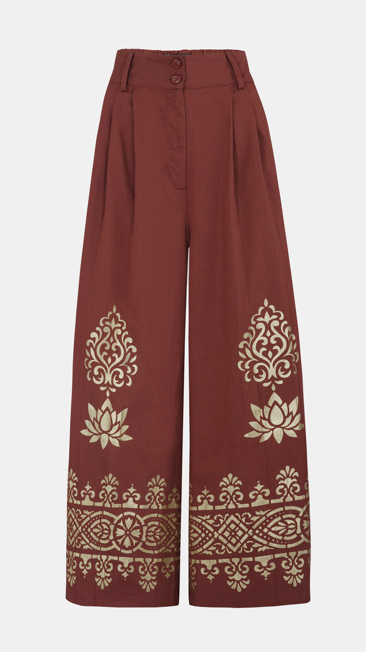 Nesavaali London Metallic Printed Wide Leg Trousers, highlighting the chic silhouette and gold accents.