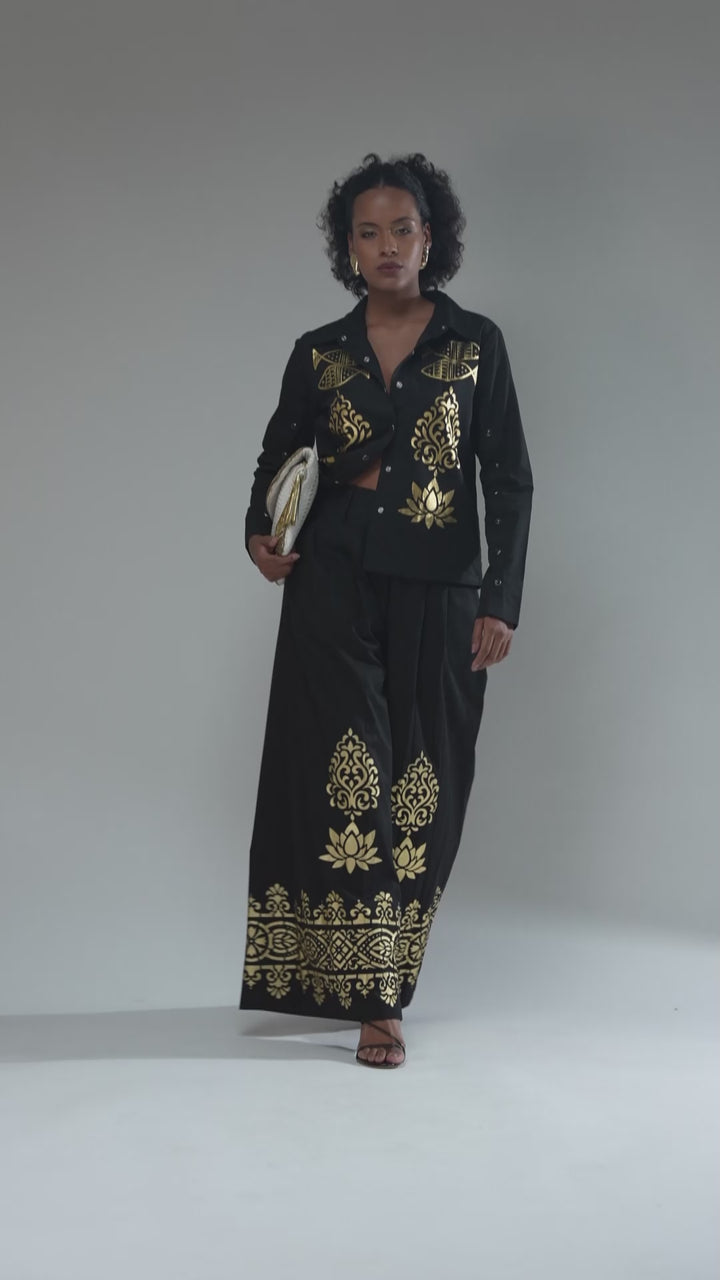 Nesavaali London Designer Screen Printed Black Wide Leg Trousers, illustrating their soft cotton fabric and stylish features.